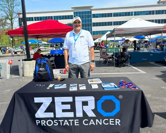 Eric Morrow standing behind a ZERO table at an event
