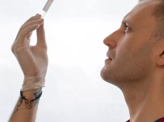 Close-Up Shot of Man Holding a Test Tube