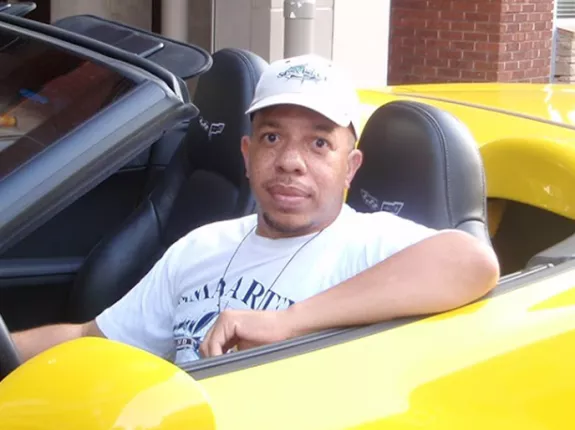 Jeff Fortson in a yellow convertible 