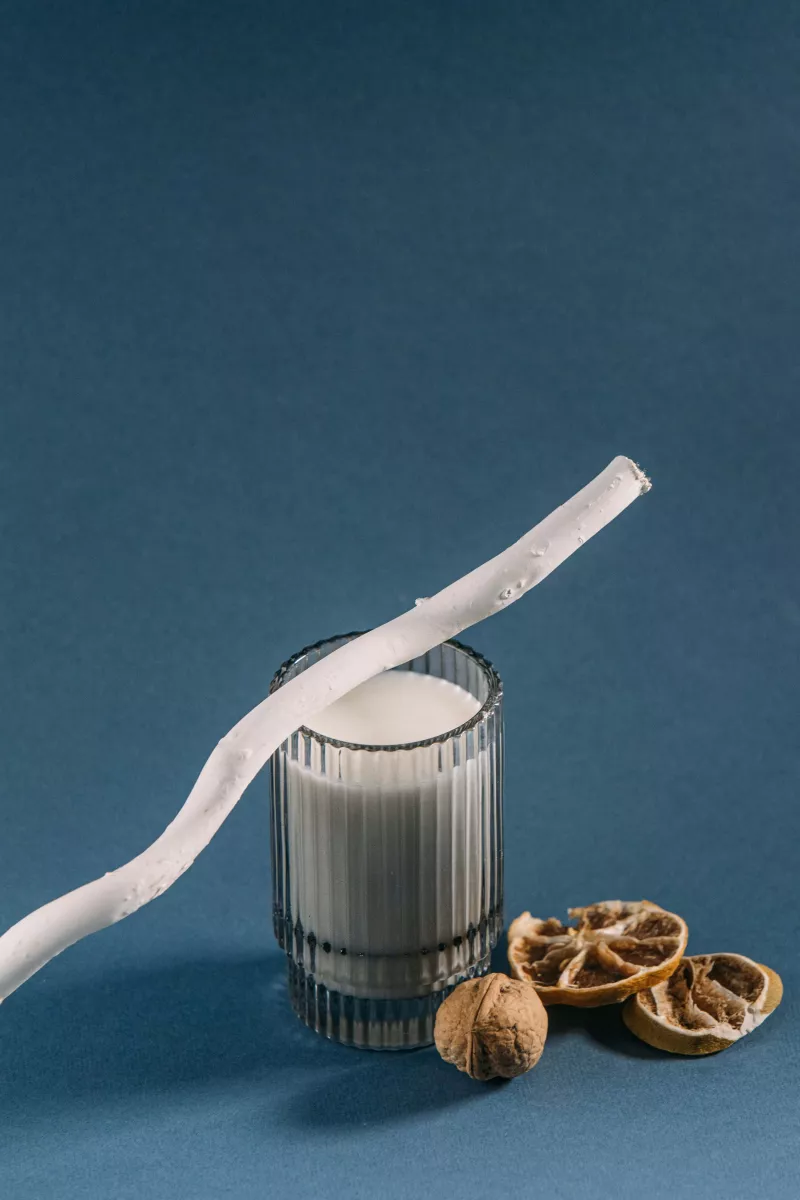 Straw on Top of Glass of Milk with walnuts