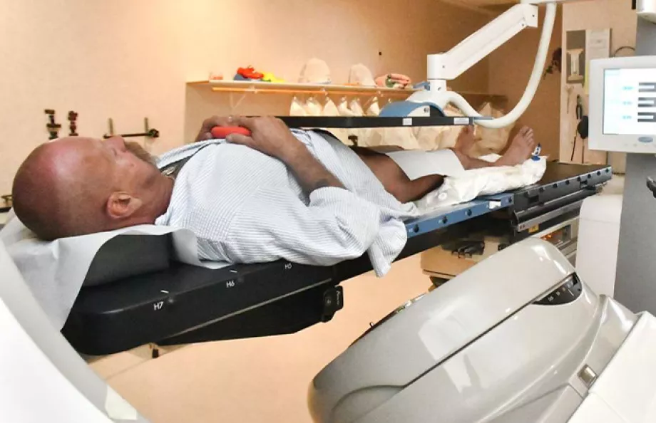 A man laying on a medical table receiving medical treatment