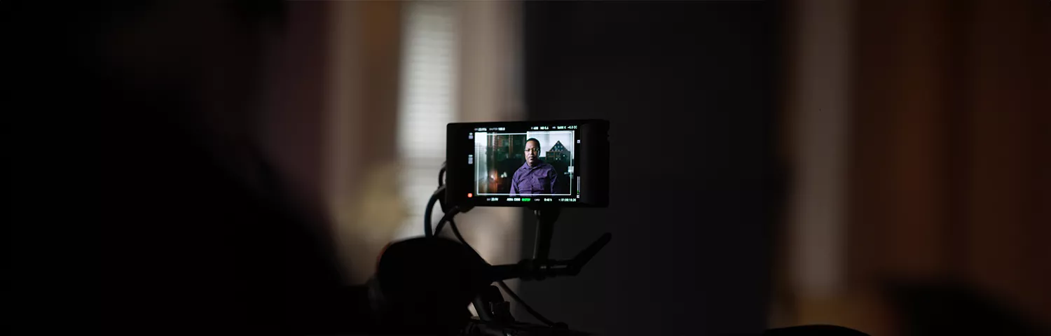 Tony Minter on a camera while being recorded