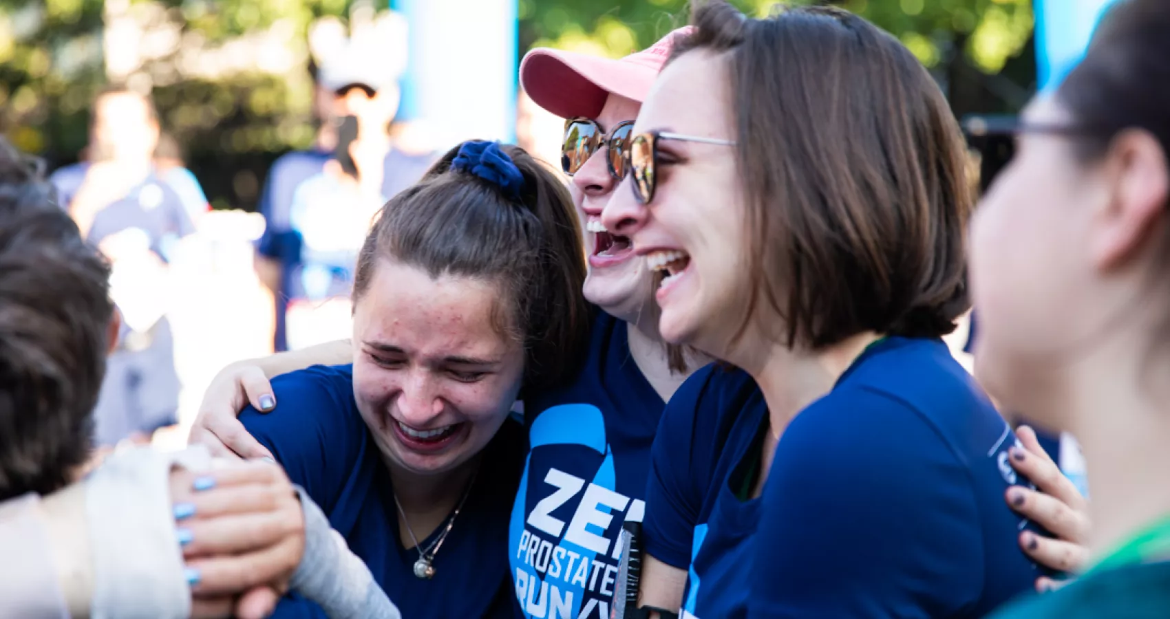 Three women hugging each other and crying