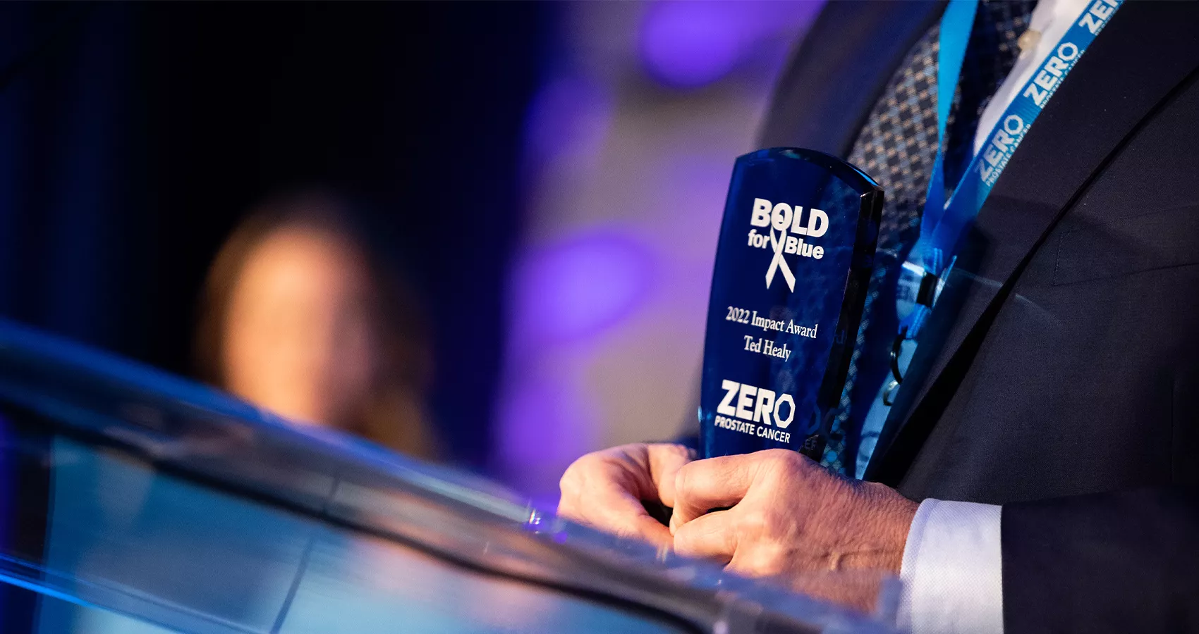 A shot of someone's hands at the podium holding a Bold for Blue award