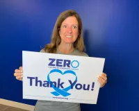Sandy Maxey holding up a thank you ZERO sign
