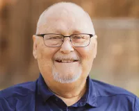 Elderly bold man wearing glasses and smiling