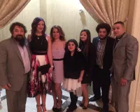 A large Latino family posing for a family photo