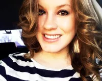 Young woman in a black and white striped top