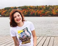 Young redhaired woman sitting on a dock