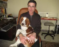 Man holding a beagle in his lap