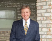 A man dressed up in a navy suit