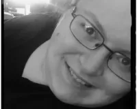 Young woman with eye glasses posing in front of a camera