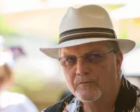 Caucasian male with glasses wearing a Panama hat
