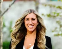 Young woman with long blond hair wearing a black blazer