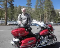 Caucasian man standing next to a red bike