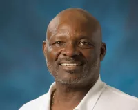 African American man in a white polo shirt