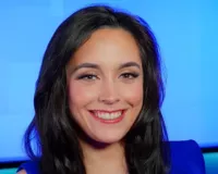 Woman with dark black hair smiling