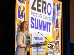 Shelby Moneer speaking at the podium with a ZERO Summit backdrop during Summit 2023