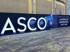 Sign that says "ASCO" in the middle of a large hallway
