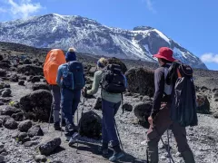 Hikers moving up the side of a mountain