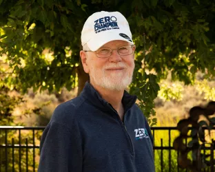 ZERO Champion Darrell Wilson standing in front of greenery