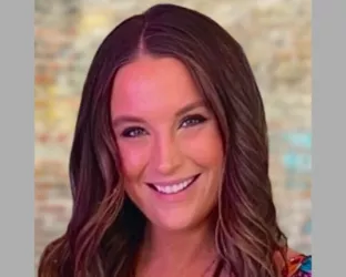 Woman with dark long brown hair smiling