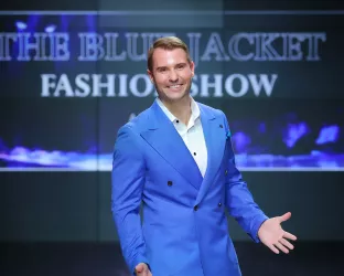 White man walking a runway in an all blue suit