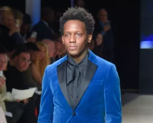 NY Post and Extra Reporter, Carlos Greer walking the runway