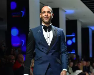 NY1 Reporter, Louis Finley, wearing a tuxedo on the runway