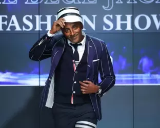 Celebrity Chef, Marcus Samuelsson, tipping his hat on the runway