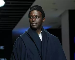 Actor, Souleymane Sy Savane walking the runway