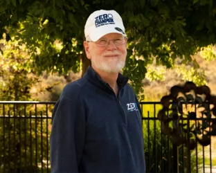 Darrell Wilson wearing blue shirt and white baseball cap