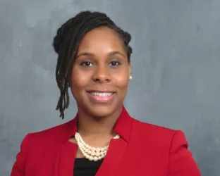 Headshot of Dr. Ewing in red blazer 