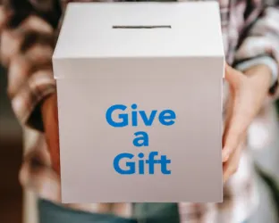 Man holding box that says 'Give a Gift'