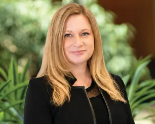 Headshot of Colleen Wood in front of plant