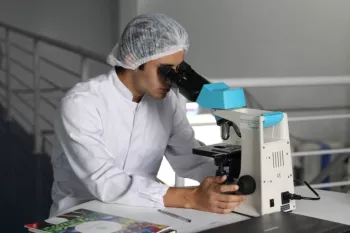 researcher using microscope