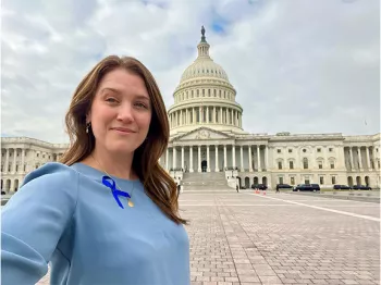 ZERO Champion wearing blue ribbon outside of the Capitol building