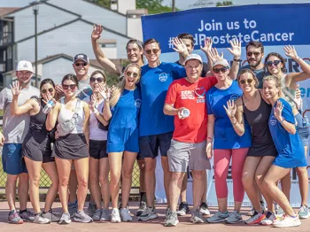 Large group of people smiling and waving at the 2022 Tulsa Run/Walk