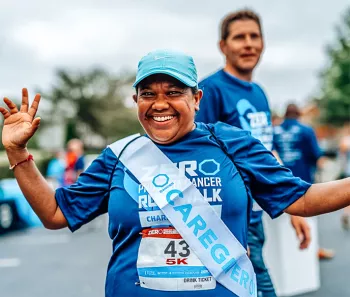 Woman wearing a caregiver sash at a Run/Walk event