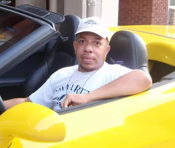 Jeff Fortson in a yellow convertible 