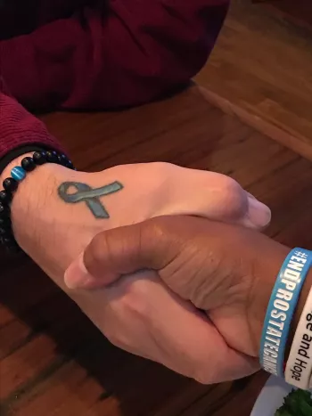 blue ribbon tattoo on Mike's hand