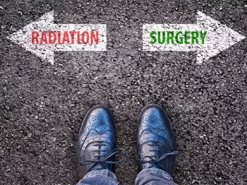 Looking down at shoes in front of two arrows going in opposite directions, one saying "Radiation" on an arrow pointing left, and one saying "surgery" on an arrow pointing right