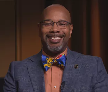 Dr. Kelvin Moses smiling with a big bow tie