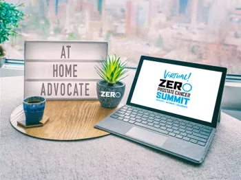 Laptop with sign next to it that says "At Home Advocate"