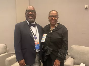 Dr. Reggie Tucker-Seely standing next to a woman at an event