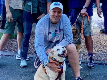 Champion Ted Healy crouched down by his dog
