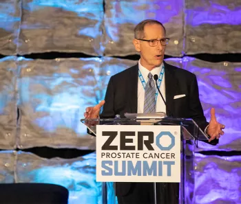 Tom Bognanno standing at the podium at the 2023 Summit