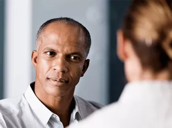 A man sitting across from his doctor