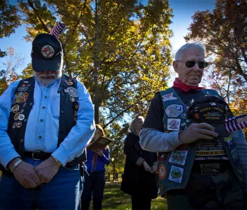 Two veterans with their heads down