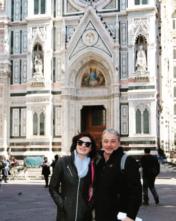 Athena and father Deno at a cathedral